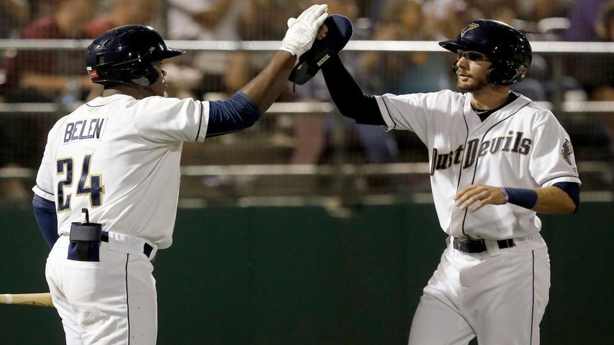 
Tri-City’s Justin Pacchioli (4) high-fives teammate Carlos Belen (24) after scoring a run during Saturday’s Game 2 of the NWL championship against the Hillsboro Hops at Gesa Stadium in Pasco.  See more photos at www.tricityherald.com. 
