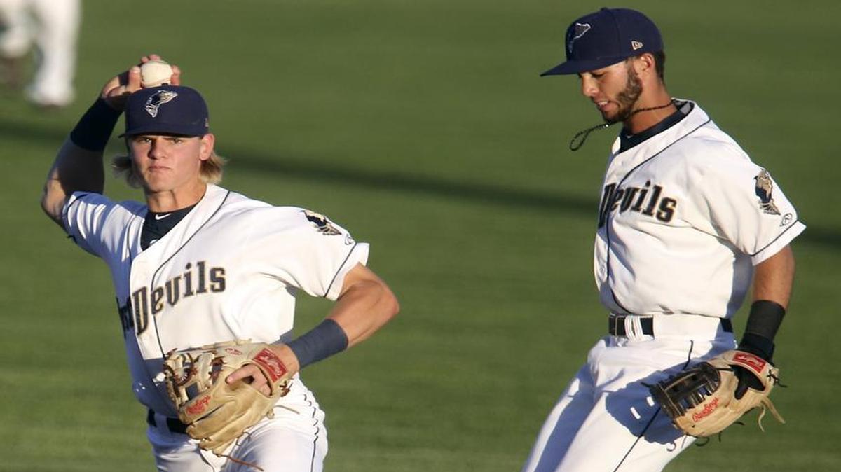 Tri-City’s Chris Baker, left, forces out Spokane’s Blaine Prescott (2) during a game earlier this season at Gesa Stadium.