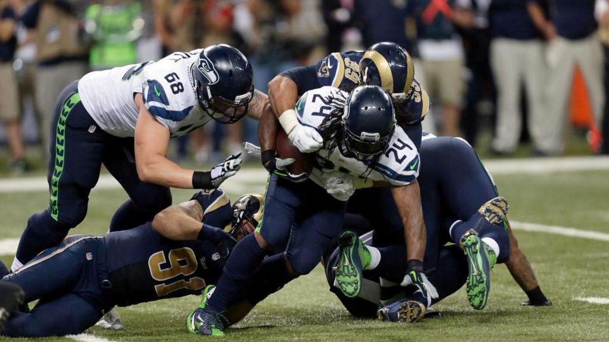 
Seahawks running back Marshawn Lynch (24) struggles for yardage against the Rams during Sunday’s season opener in St. Louis. Lynch came up short on fourth and 1 in overtime as Seattle lost 34-31.
