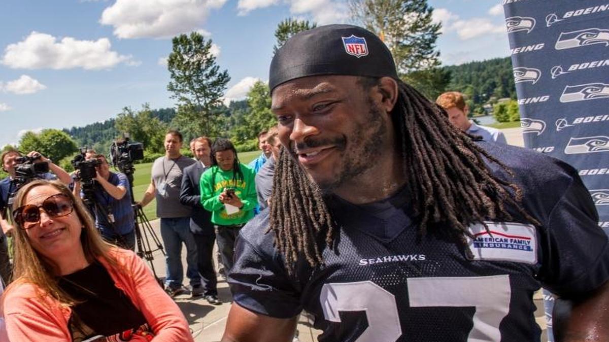 New running back Eddie Lacy of the Seattle Seahawks is greeted by coach Pete Carroll after a press interview at an off-season practice at the football team’s Renton facility on Friday.
