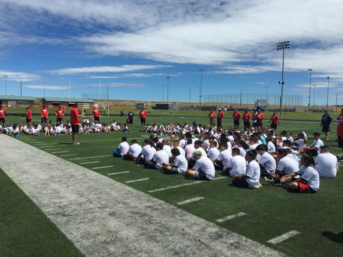Participants at Sunday’s NFL Play 60 Character Camp at Chiawana High School listen to a speech from one of the camp’s coaches.