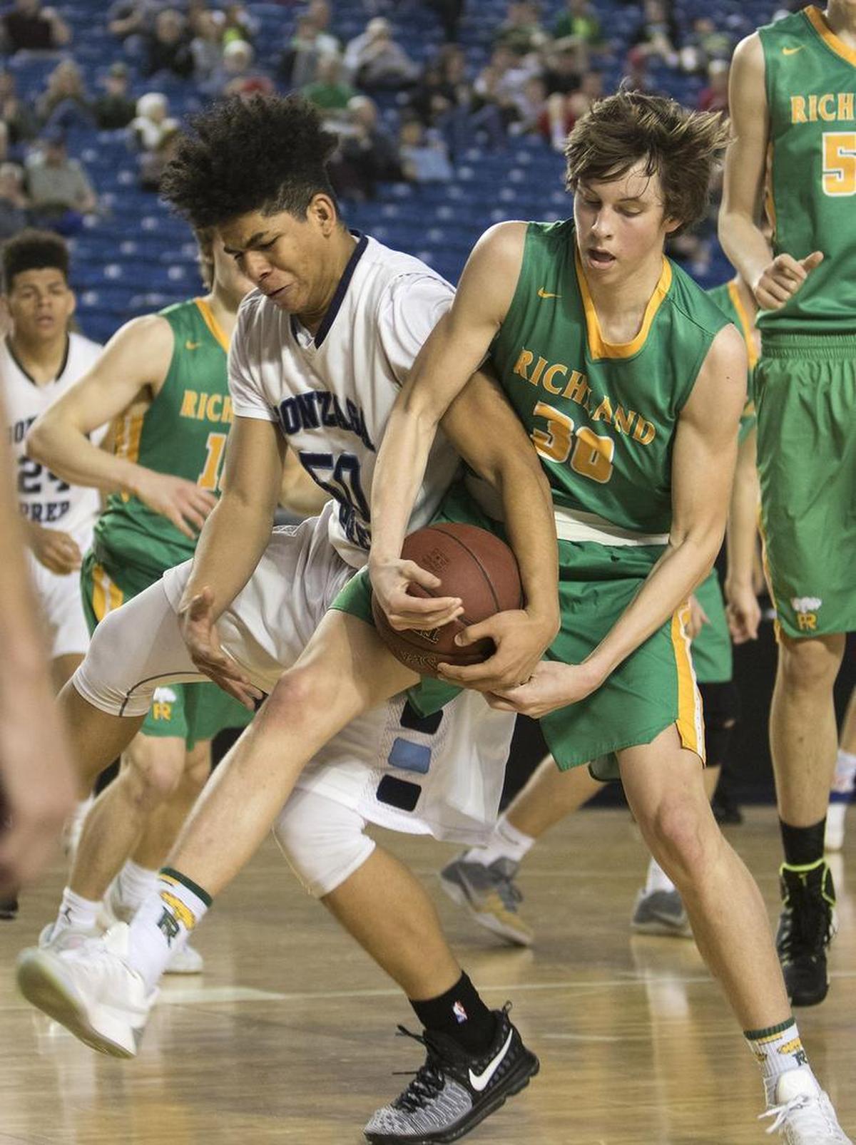 Richland's Garrett Streufert, right, battles Gonzaga Prep's Jamaari Jones for a rebound Saturday, March 4, 2017, during their consolation game at the 4A Boys State Basketball Tournament in Tacoma, Wash. (Photo by Patrick Hagerty)
