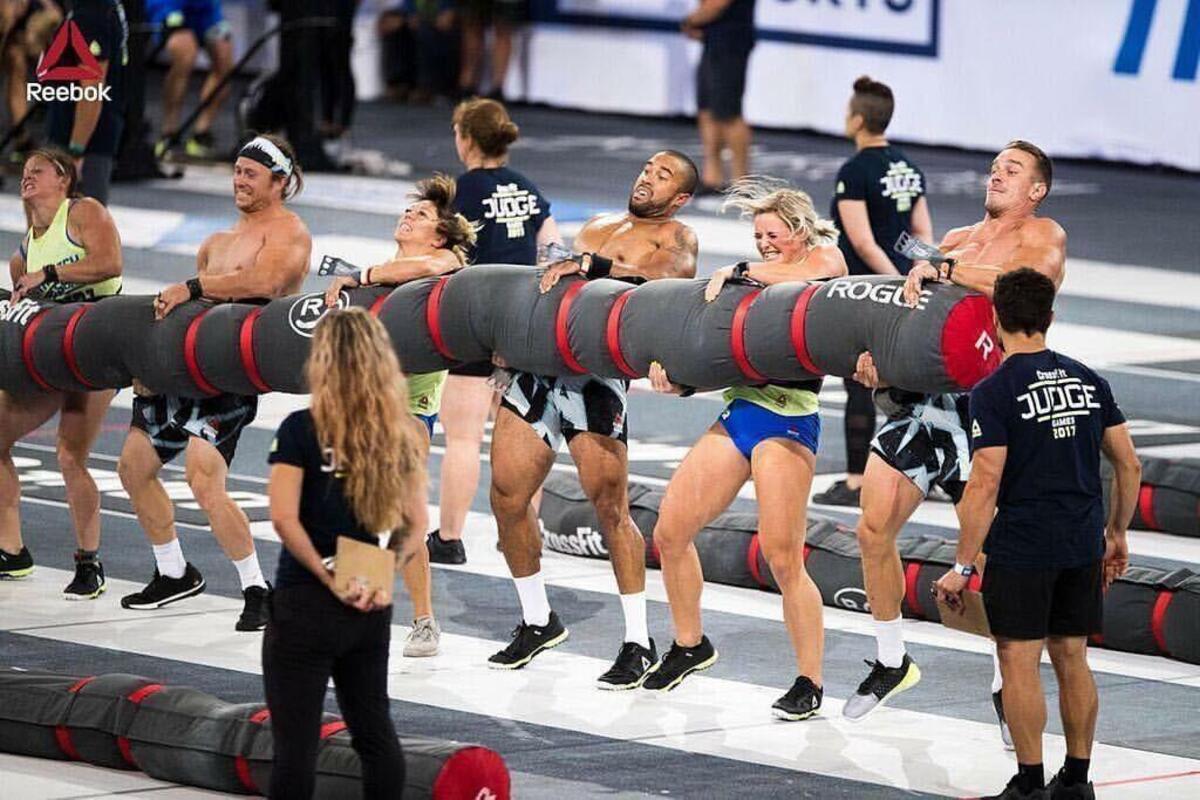The Wasatch CrossFit team of Mandi Janowitz, Mitch Spjut, Tiffany Hendrickson, Adrian Conway, Michaela North and Brennan Fjord lift a 550-pound “worm” during the rowing worm event the at the Reebok Crossfit Games that were held Aug. 3-6 in Madison, Wisc.