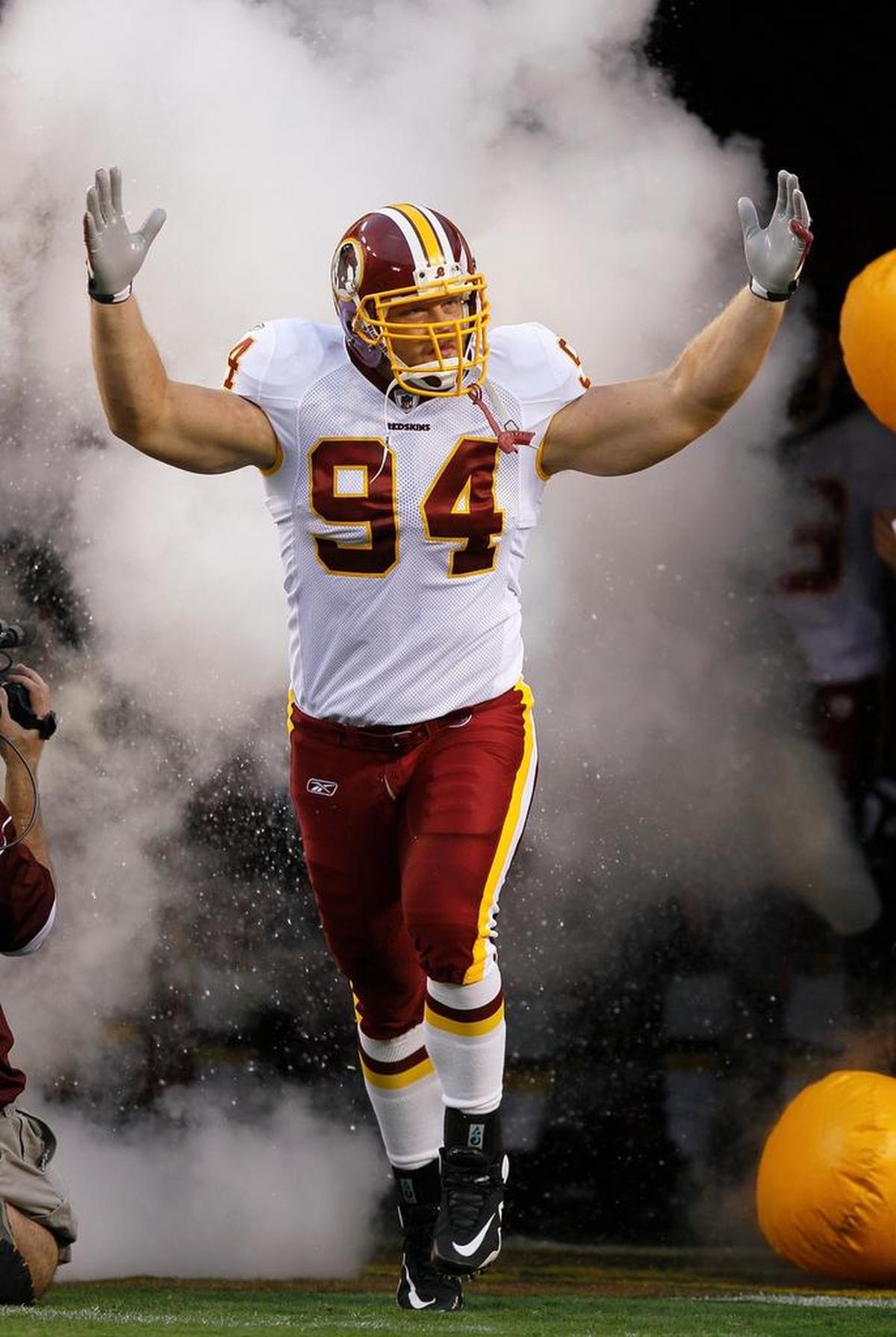 Washington Redskins defensive lineman Adam Carriker pumps up the crowd as he enters the field before a preseason game against the Buffalo Bills in 2010.