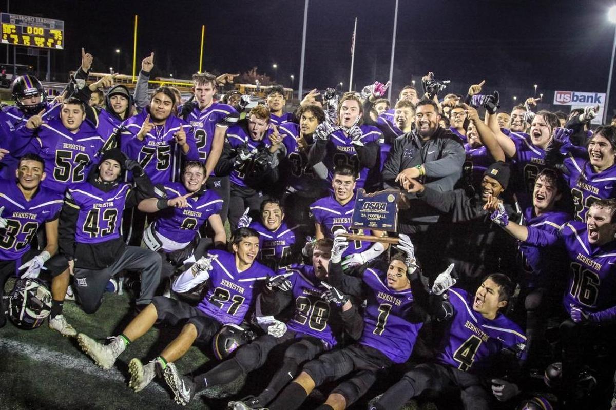 The Hermiston football team poses for a photo after winning the OSAA 5A state championship 38-35 over Churchill on Nov. 25.