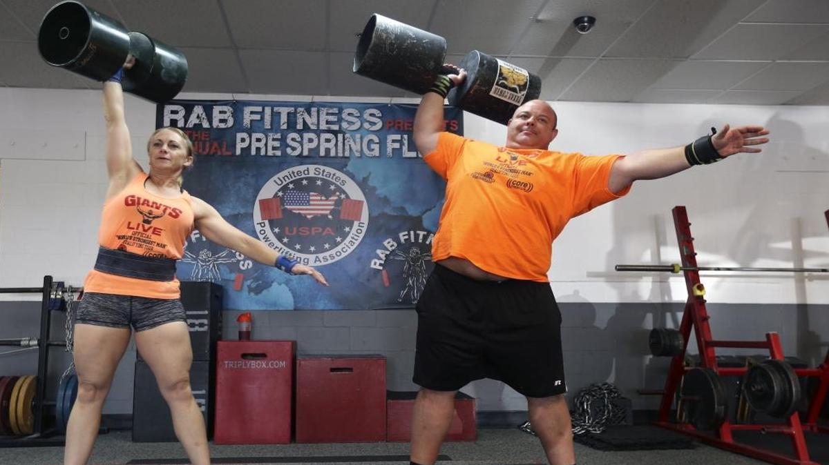 Lisa Kromer, and husband Mike lift circus barrels at RAB Fitness in Kennewick. They travel across the country participating in Strongman competitions and have even made it a family affair with sons Xavier and Samuel frequently joining them at the gym.