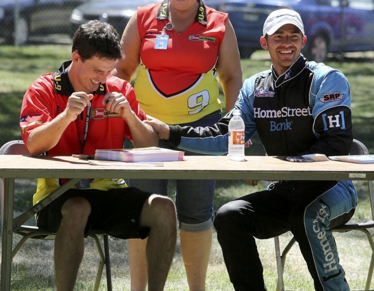 U-1 Miss HomeStreet driver Jimmy Shane, right, laughs as he puts a temporary tattoo on one of his competitors, Andrew Tate, during an autograph session at the 2016 Tri-City Water Follies at Columbia Park in Kennewick. Tate, the 2016 H1 Unlimited Rookie of the Year, bested Shane in the final heat of the Madison Regatta in early July in Illinois.