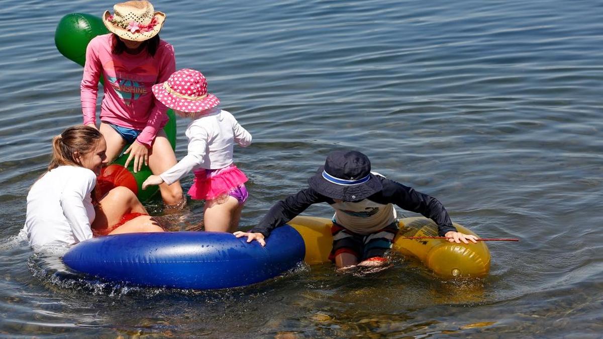Siblings, from right, Derek, 6, Cambria, 4, Alyssa, 10, and Ellie, 13, Marsh struggle to stay on an inner tube together Friday during the first day of Water Follies at Columbia Park in Kennewick.