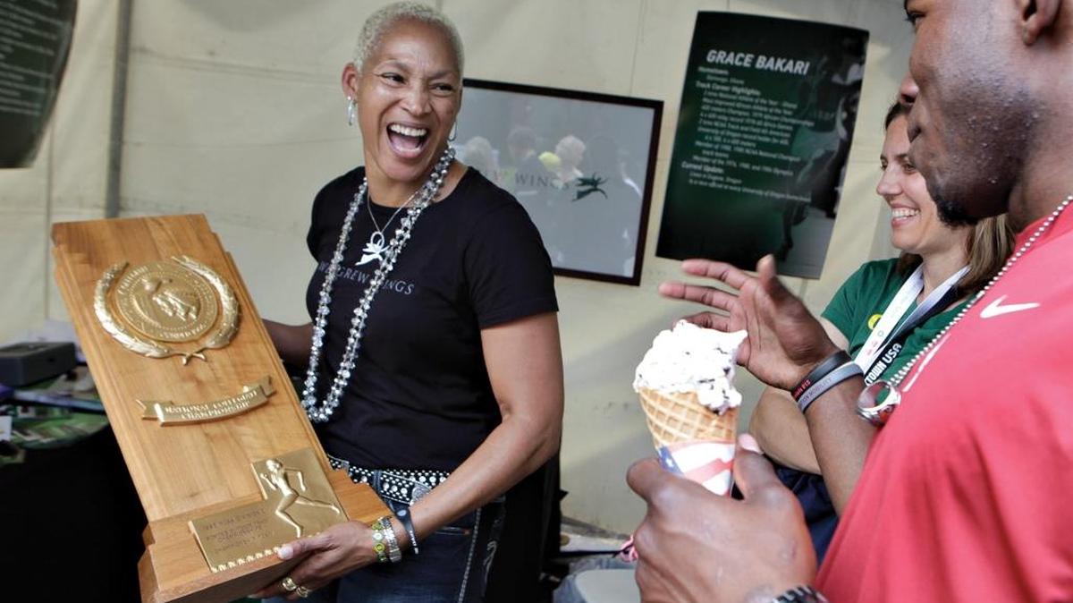 In this 2012 photo, Quenna Beasley, left, a 1980 Pasco High School graduate, shares a laugh with her son, Logwone Mitz, and her former University of Oregon track and field teammate Claudette Groenendaal while holding the 1985 NCAA Women’s Outdoor Track Championships team trophy.
