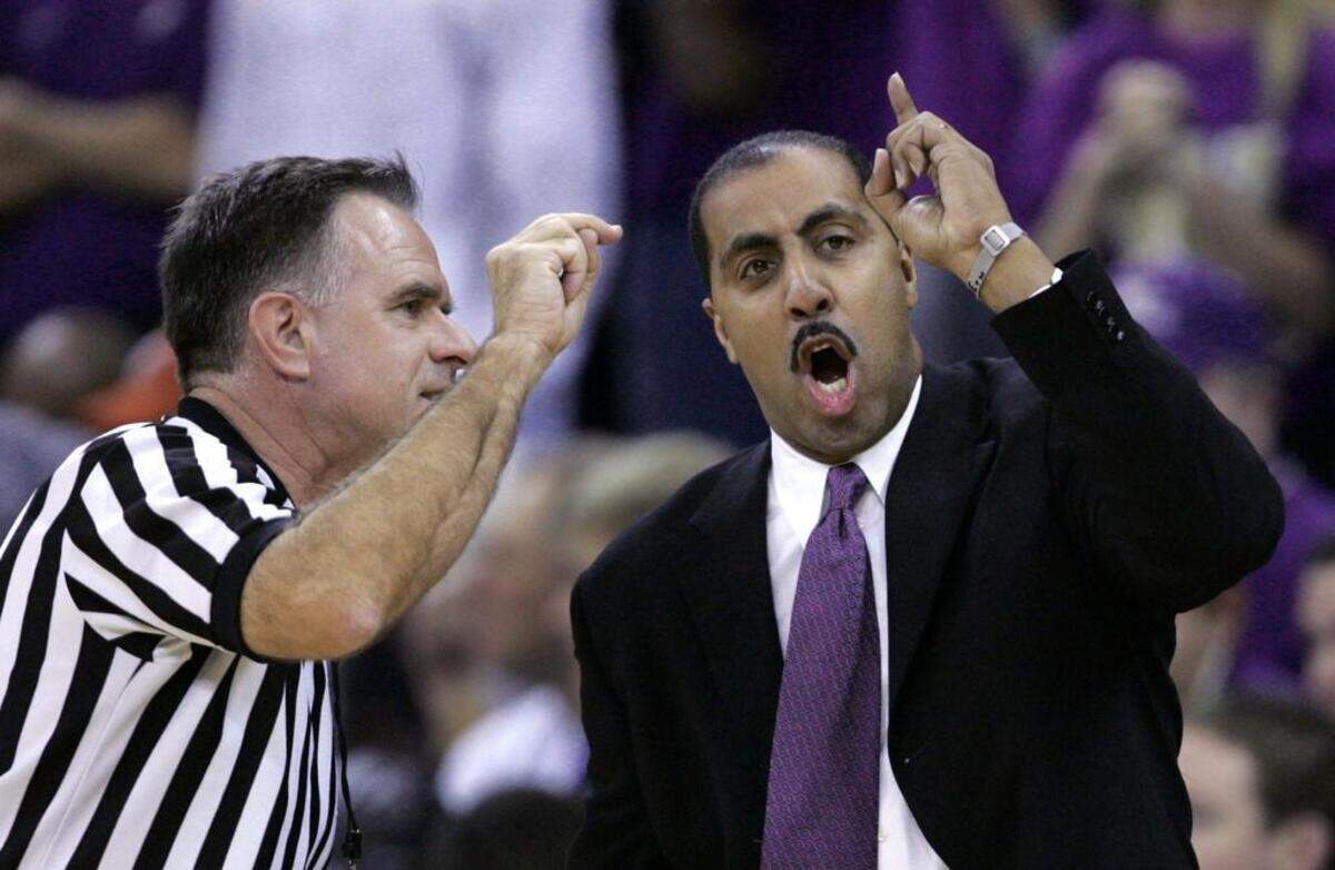 Washington coach Lorenzo Romar, right, argues with official Dick Cartmell in the first half against North Carolina State Sunday, Dec. 19, 2004, in Seattle. Washington upset the Wolfpack, 68-64. (AP Photo/Elaine Thompson)
