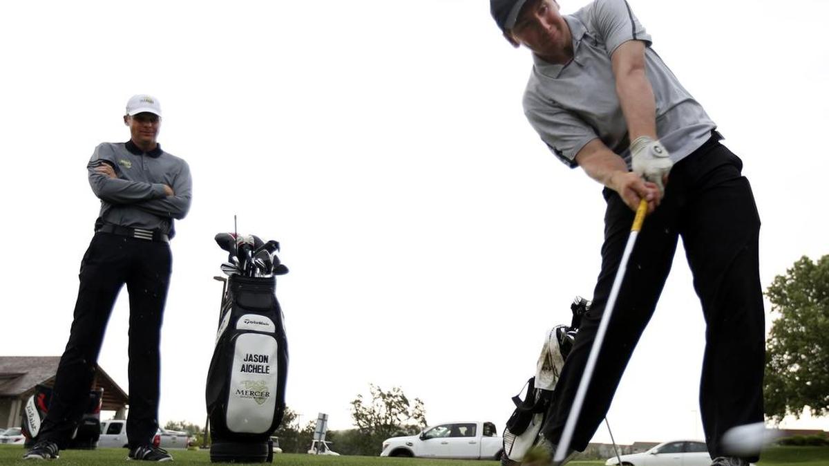 PGA teaching pro Jason Aichele looks on as his student Drew McCullough, who plays for the University of Wyoming, hits a ball at the driving range during a recent session at Meadow Springs Country Club in Richland. Aichele has set up an indoor facility at Meadow Springs that allows him to work year-round with students, and he’s starting to produce champions.