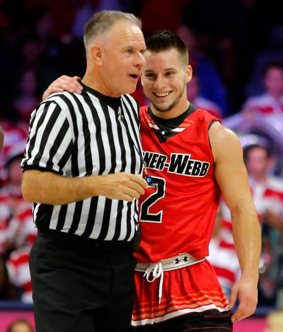 Gardner Webb guard Tyler Strange (2) talks to NCAA official Dick Cartmell during the first half of an NCAA college basketball game against Arizona, Tuesday, Dec. 2, 2014, in Tucson, Ariz. (AP Photo/Rick Scuteri)