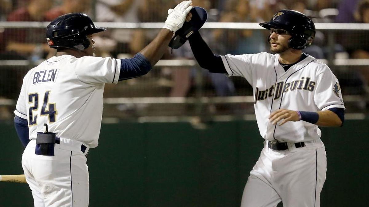 Tri-City Dust Devils’ Justin Pacchioli (4) high-fives teammate Carlos Belen (24) after scoring a run during Game 2 of the Northwest League Championships against the Hillsboro Hops at Gesa Stadium in Pasco. The Dust Devils’ run to the NWL title series was the No. 1 Mid-Columbia sports story for 2015.