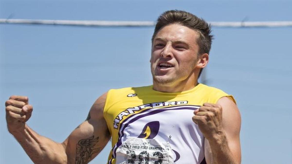 Hanford’s Joseph Gauthier, left, celebrates his first-place finish in the 4A 100-meter final May 27 at the state track and field meet in Tacoma. Gauthier will compete at the USATF Hershey National Junior Olympic Track & Field Championships next week in Lawrence, Kan.