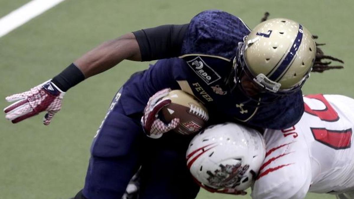 Tri Cities’ Joseph Snell, left, breaks through a tackle by Billings’s Wyatt Johnson during Saturday’s IFL game at the Toyota Center.