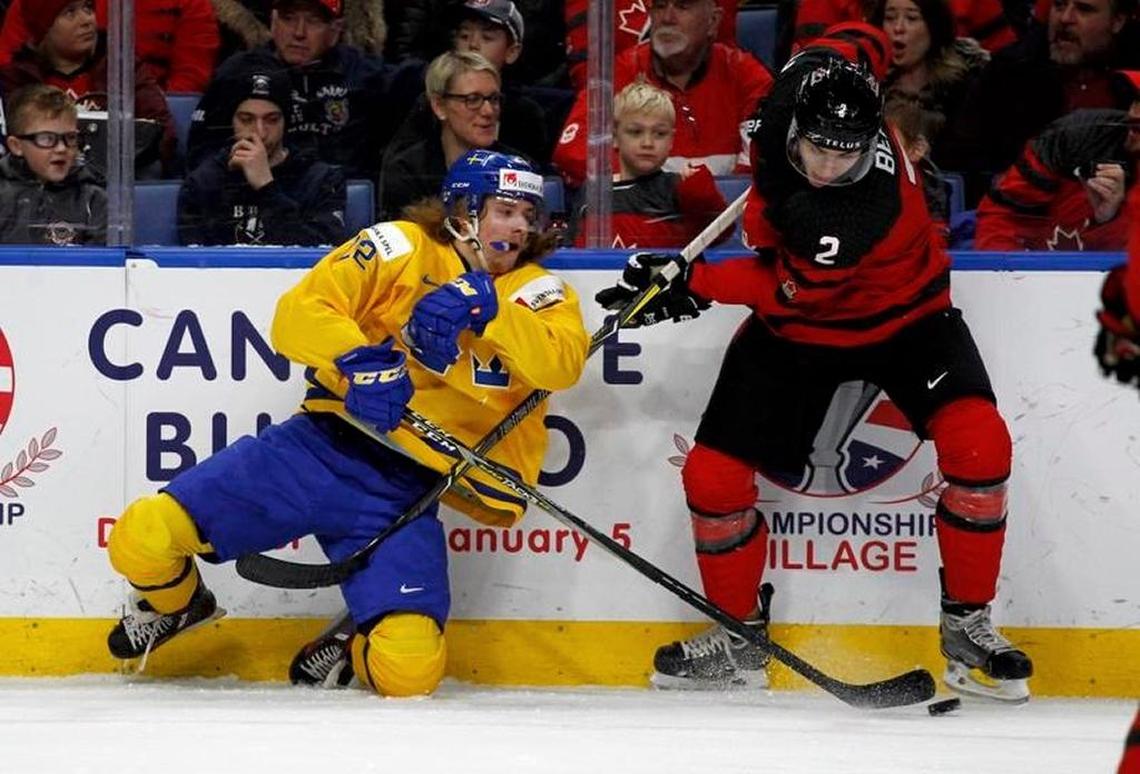 Canada defenseman Jake Bean (2) and Sweden forward Axel Jonsson Fjallby (22) collide during the first period of the Jan. 5 gold medal game of the World Junior Championship in Buffalo, N.Y.