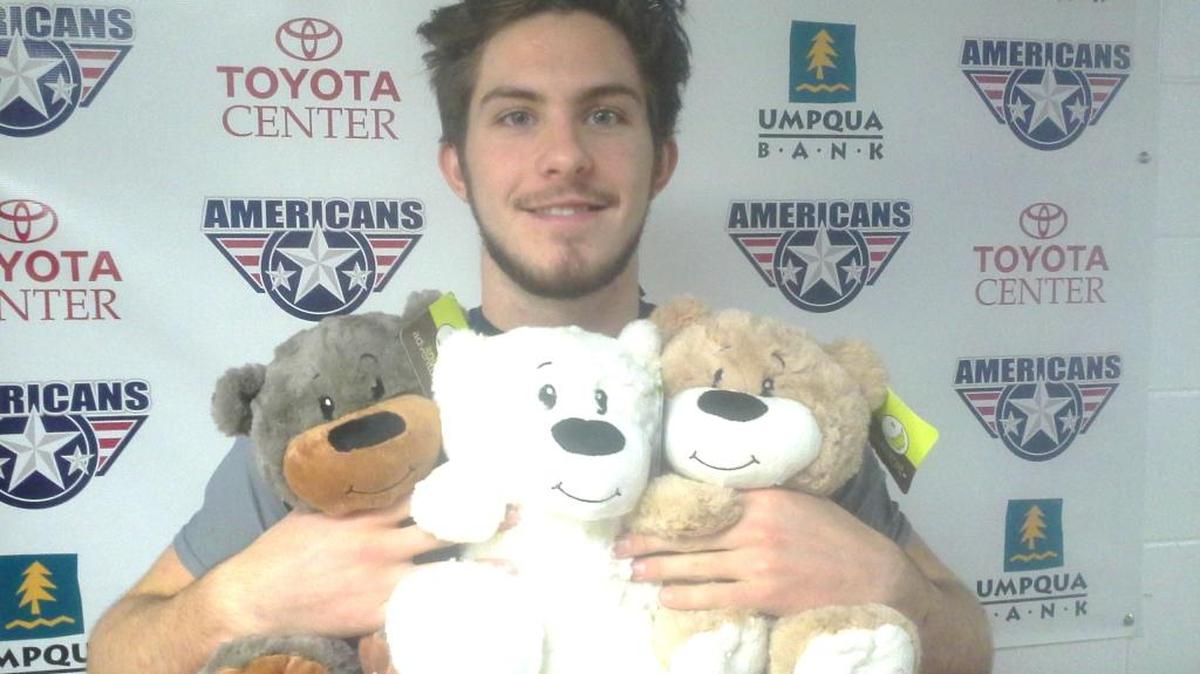 Tri-City forward Parker Bowles hugs bears that will be available for purchase at Friday night’s game.