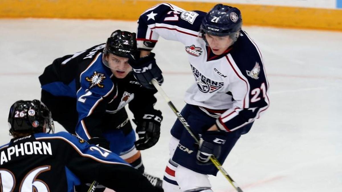 Tri-City’s Vladislav Lukin (21) takes a shot past Kootenay’s Noah Philp and Kaeden Taphorn (26) during Friday’s game at Toyota Center in Kennewick. The Americans beat the Ice 7-4.