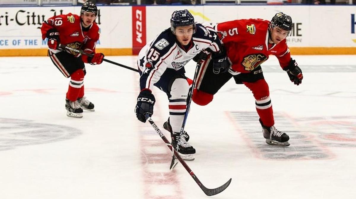 Tri-City’s Michael Rasmussen (15) and Portland’s Matthew Quigley (5) go after the puck in the first period of Friday’s game at Toyota Center. The Americans beat the Winterhawks 6-3.