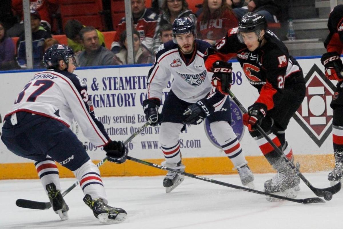 Tri-City’s Dan Gatenby (37) and Parker AuCoin (32 battle for the puck with Prince George’s Aaron Boyd (23) during Saturday’s game at Toyota Center in Kennewick.