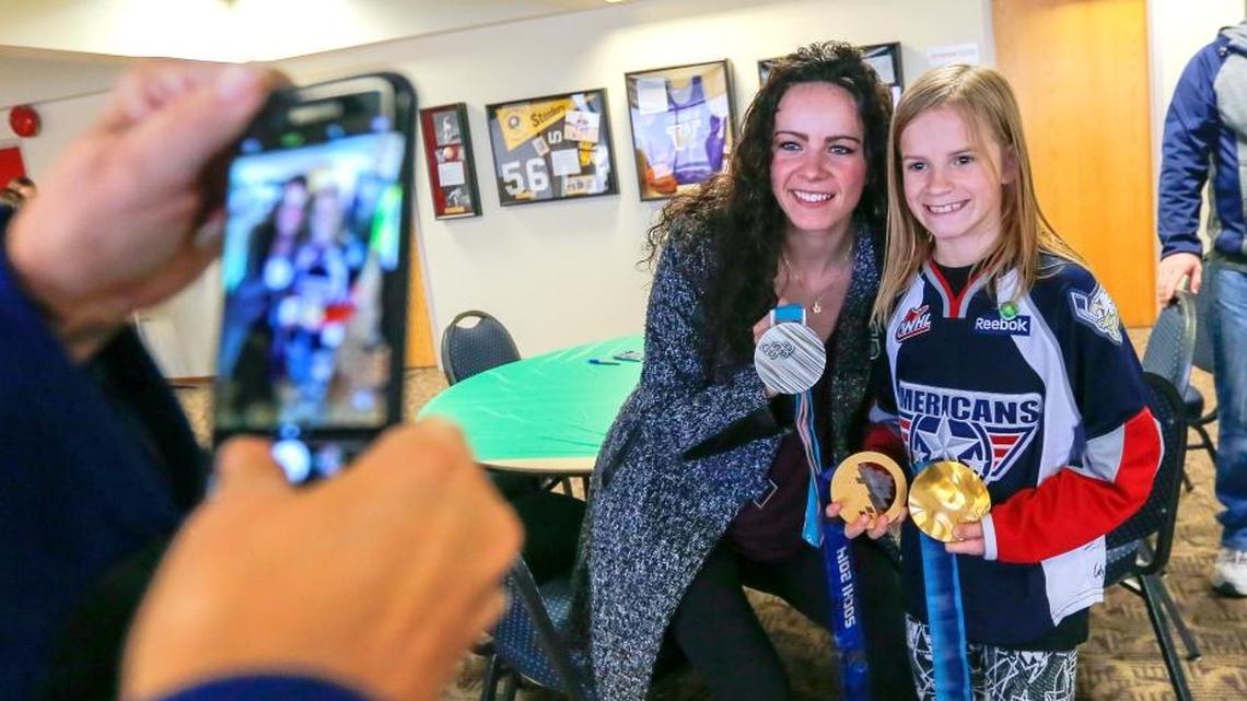 Three-time Canadian Olympian Shannon Szabados poses for a photo Saturday holding her silver medal from Pyeongchang with Cailyn Grandeen, 9, at Toyota Center during a meet and greet before the Americans played Spokane.