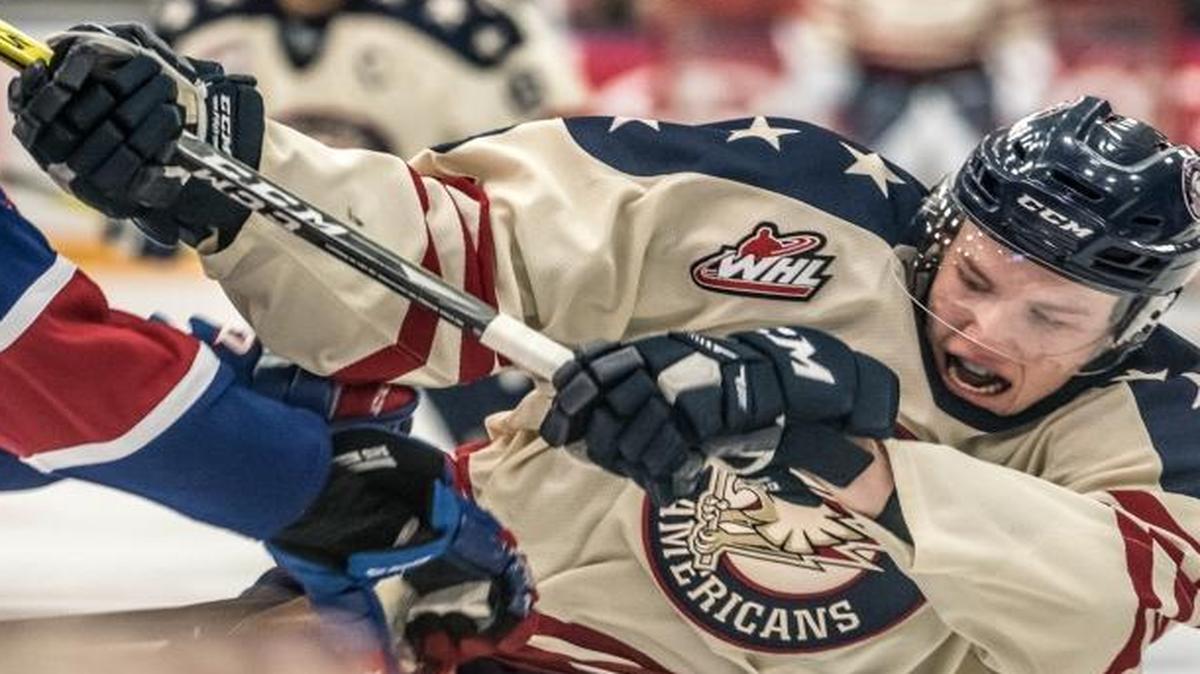 Tri-City Americans defenseman Dalton Yorke, right, gets a hard check from Spokane’s Dalton Hamaliuk during Friday’s game at Toyota Center. The Americans won 5-4 in overtime.