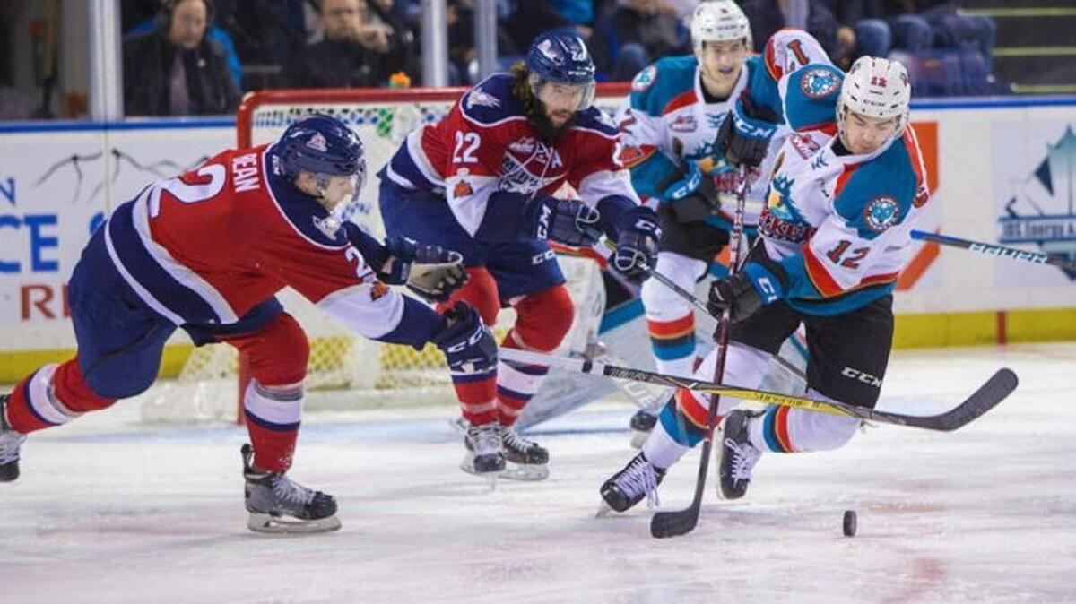 Tri-City’s Jake Bean (2) and Nolan Yaremko (22) battle Kelowna’s Erik Gardiner (12) for the puck during Saturday’s playoff game at Prospera Place in Kelowna, British Columbia. The Americans won 9-7 to take a 2-0 series lead.