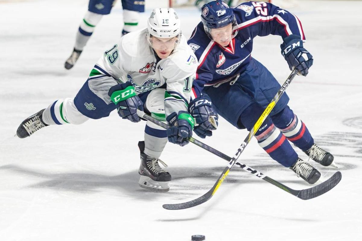 Tri-City’s Kyle Olson, right, and Seattle’s Donovan Neuls vie for the puck during a playoff game in Kent.