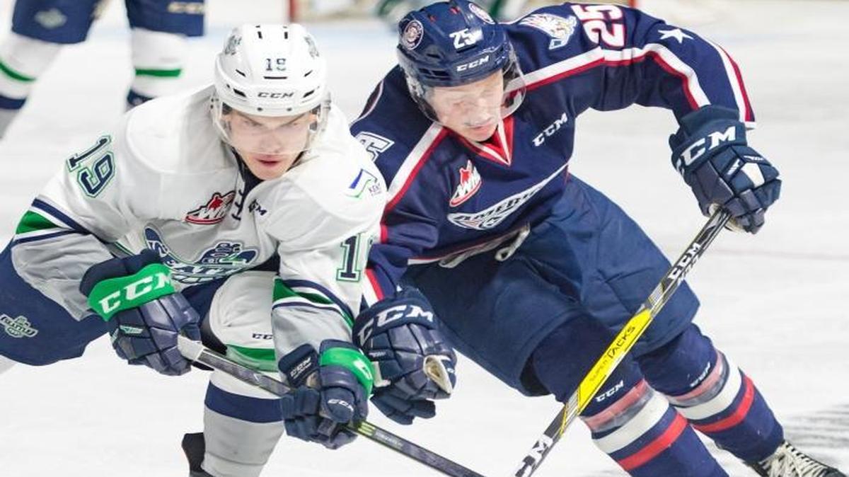 Tri-City’s Kyle Olson, right, and Seattle’s Donovan Neuls vie for the puck during Saturday’s playoff game in Kent.