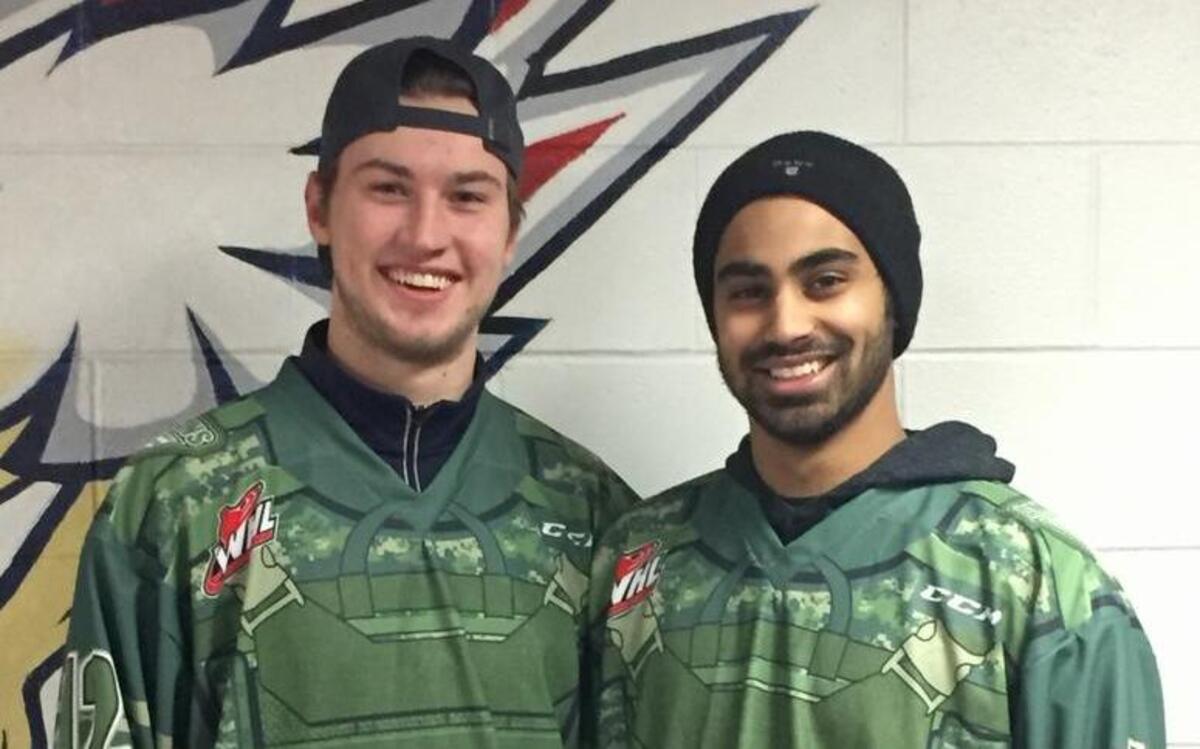 Tri-City Americans Jordan Topping, left, and Tyler Sandhu show off the team’s Military Appreciation Night jerseys, which will be auctioned off after the game.