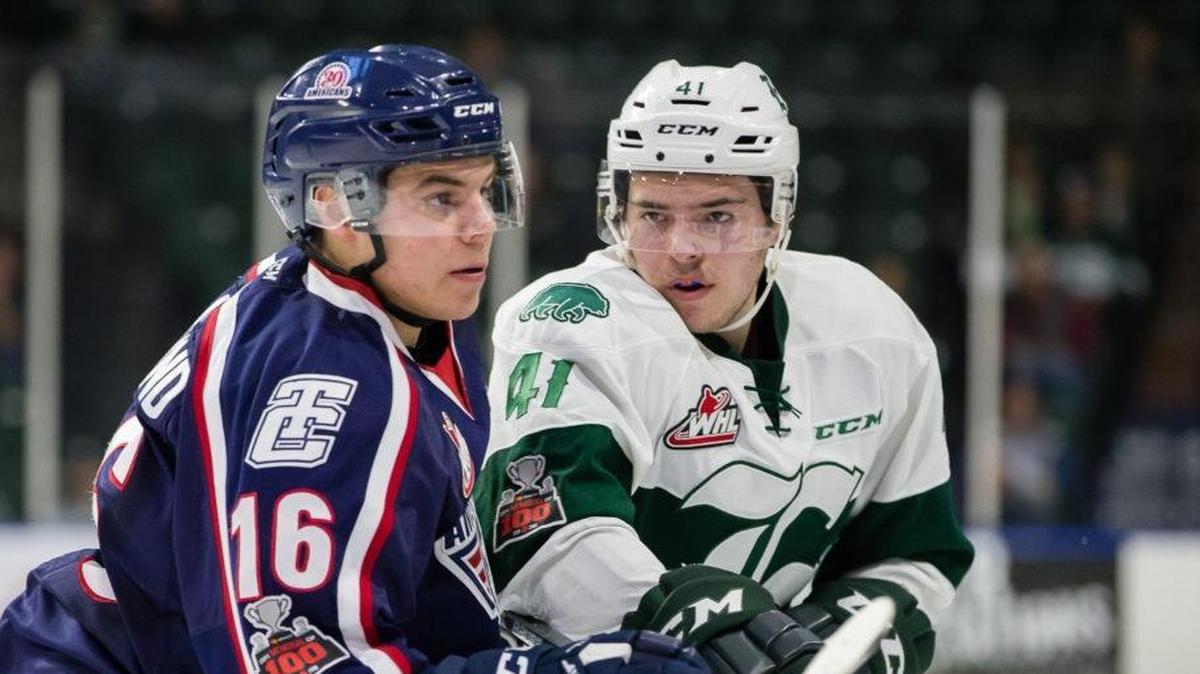 Tri-City’s Paycen Bjorklund (left) and Everett’s Garrett Pilon battle for positioning during Wednesday’s game in Everett. The Silvertips beat the Americans 4-0.