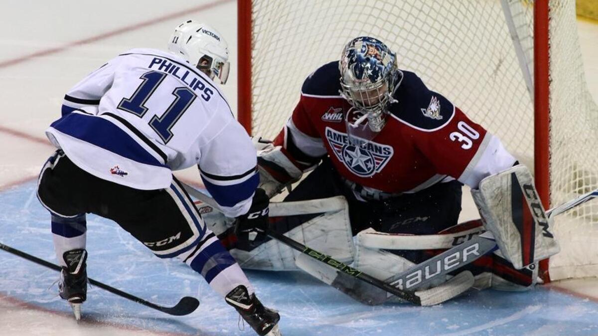 Tri-City goalie Patrick Dea stops a shot by Victoria’s Matthew Phillips during Friday’s game in Victoria, British Columbia. The Americans beat the Royals 7-0.