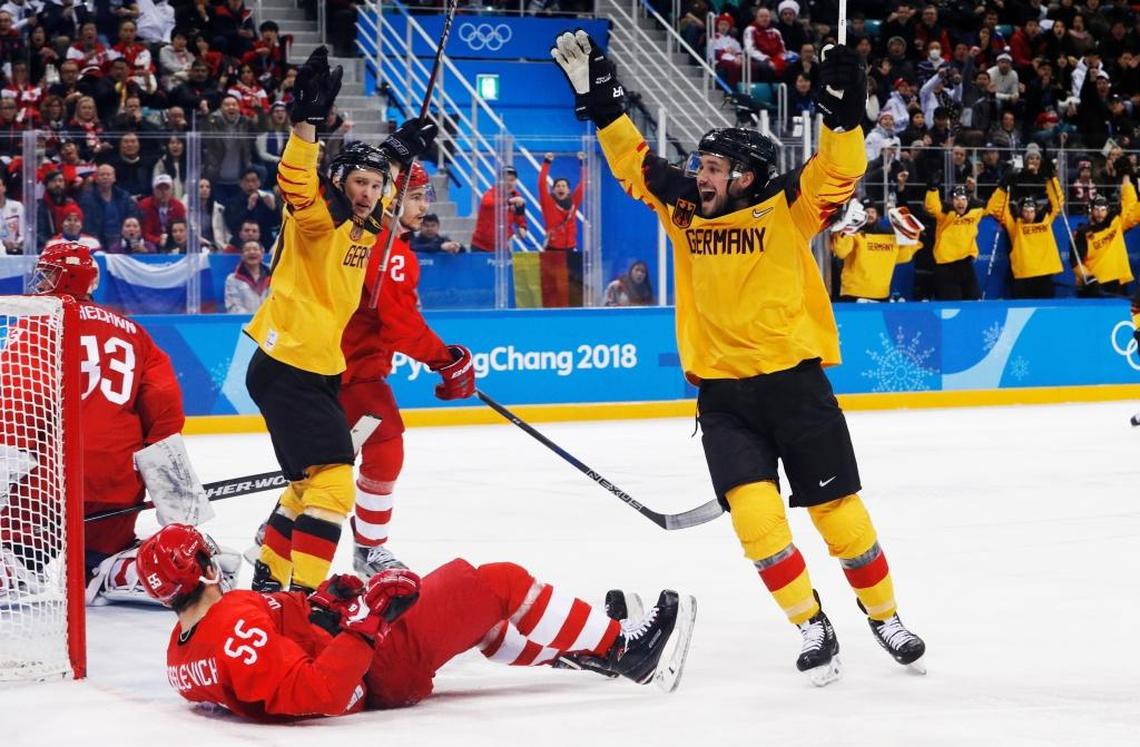 Brooks Macek, right, of Germany, and Patrick Hager celebrate past Russian athletes Bogdan Kiselevich (55), Artyom Zub (2) and Vasily Koshechkin (83) after a goal by Felix Schutz during the second period of the men’s gold medal hockey game at the 2018 Winter Olympics.