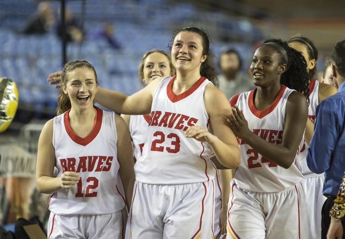 Kamiakin's Chanceler Williams, middle, and her teammates, Salee Westermeyer, left, and Oumou Toure, right, were all smiles after Williams put in the game-winning bucket in overtime Saturday, March 4, 2017, during their consolation game against Lynnwood at the 3A Girls State Basketball Tournament in Tacoma, Wash. Kamiakin won the game 66-64 and took home 4th place in State. (Photo by Patrick Hagerty)
