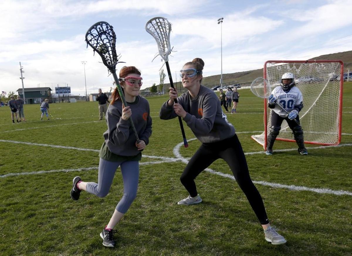 Maddy Smith, left, attempts to move past Chloe Mitchell to take a shot on goalkeeper in this 2016 photo.