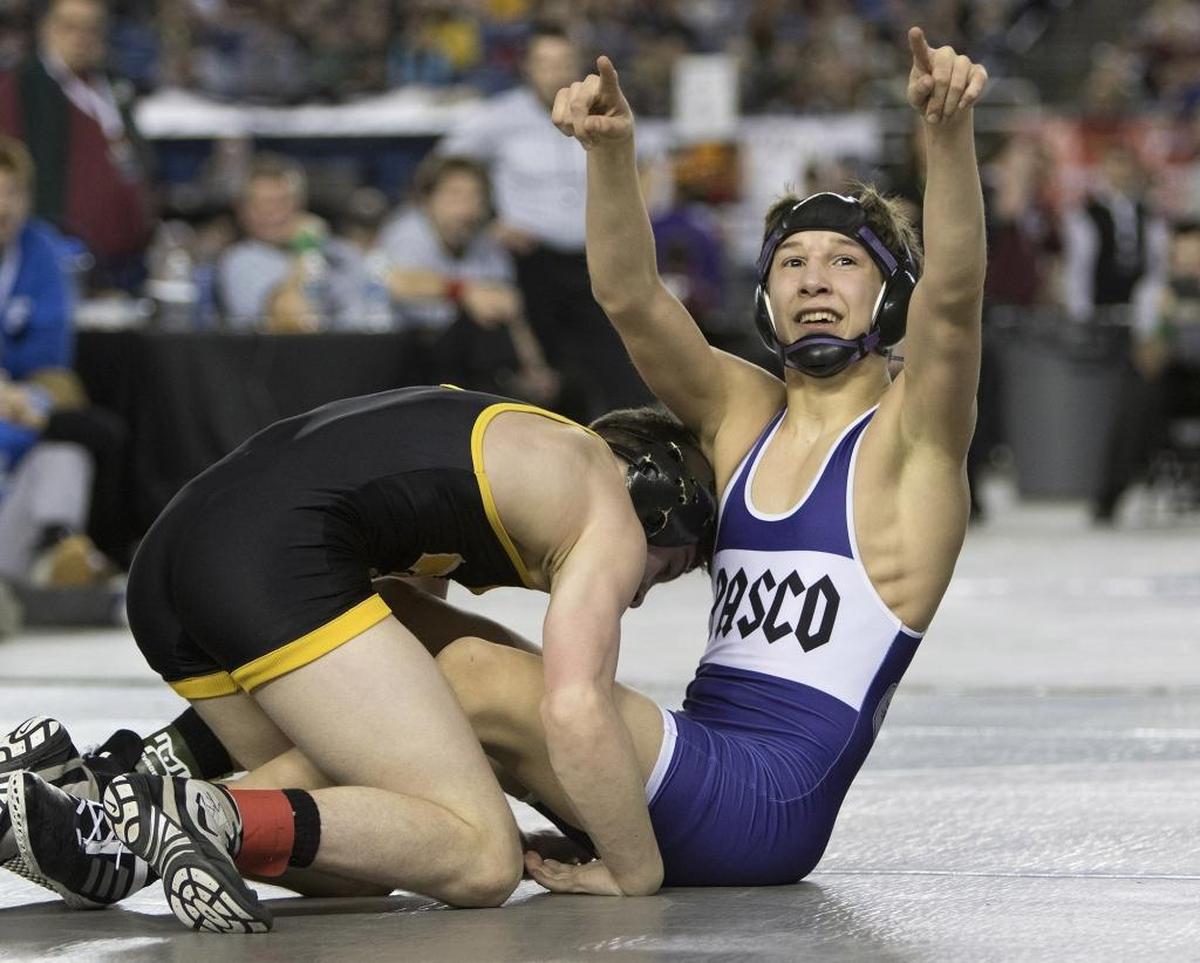 Pisco's Isaiah Gonzalez points to his fans after defeating Tahoma's Austin Michalski in their 4A 113 lb. State Wrestling championship match Saturday, Feb. 18, 2017, in Tacoma, Wash. (Photo by Patrick Hagerty)