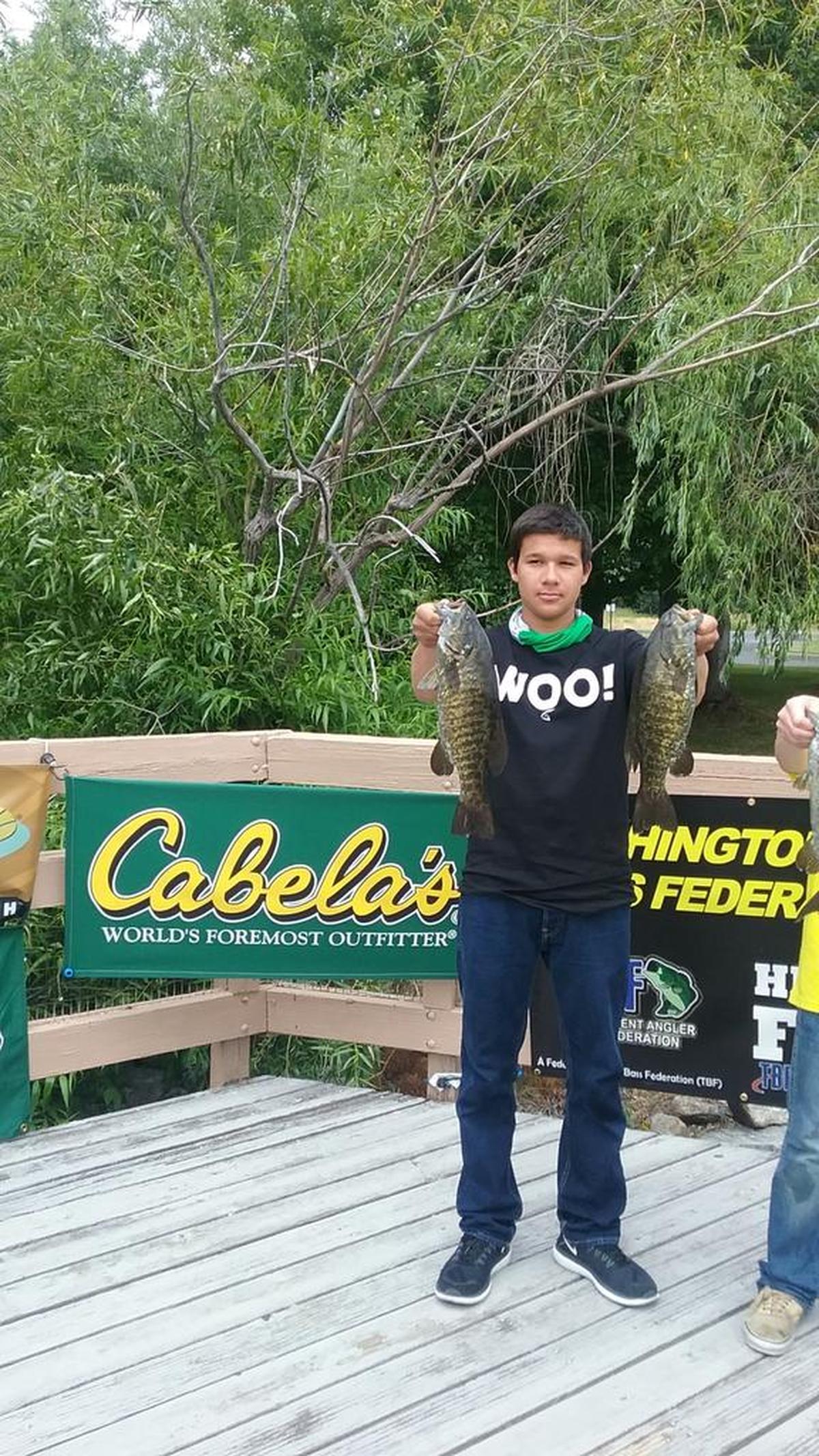 Jordan Gregory poses with a couple of his catches at the Washington Junior State Bass Fishing Championships on May 20 in Moses Lake.