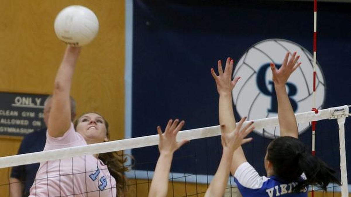 Columbia Basin College’s Mackenzie Monahan (14) spikes the ball over the net and past the block of Big Bend Community College’s McKenzi Lott (1) and Taylor Hendrickson (7) on Wednesday during a match in Pasco. See more photos at www.tricityherald.com